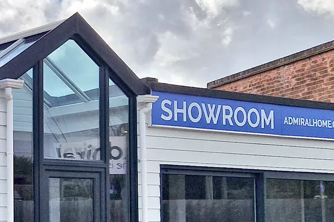 The front of the Admiral showroom in Ipswich: a glazed gable entrance under a blue Showroom sign.